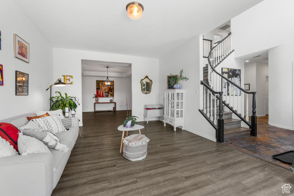 Living area featuring stairs, baseboards, and wood finished floors