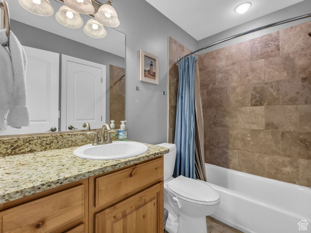 Full bath featuring vanity, shower / tub combo with curtain, and toilet