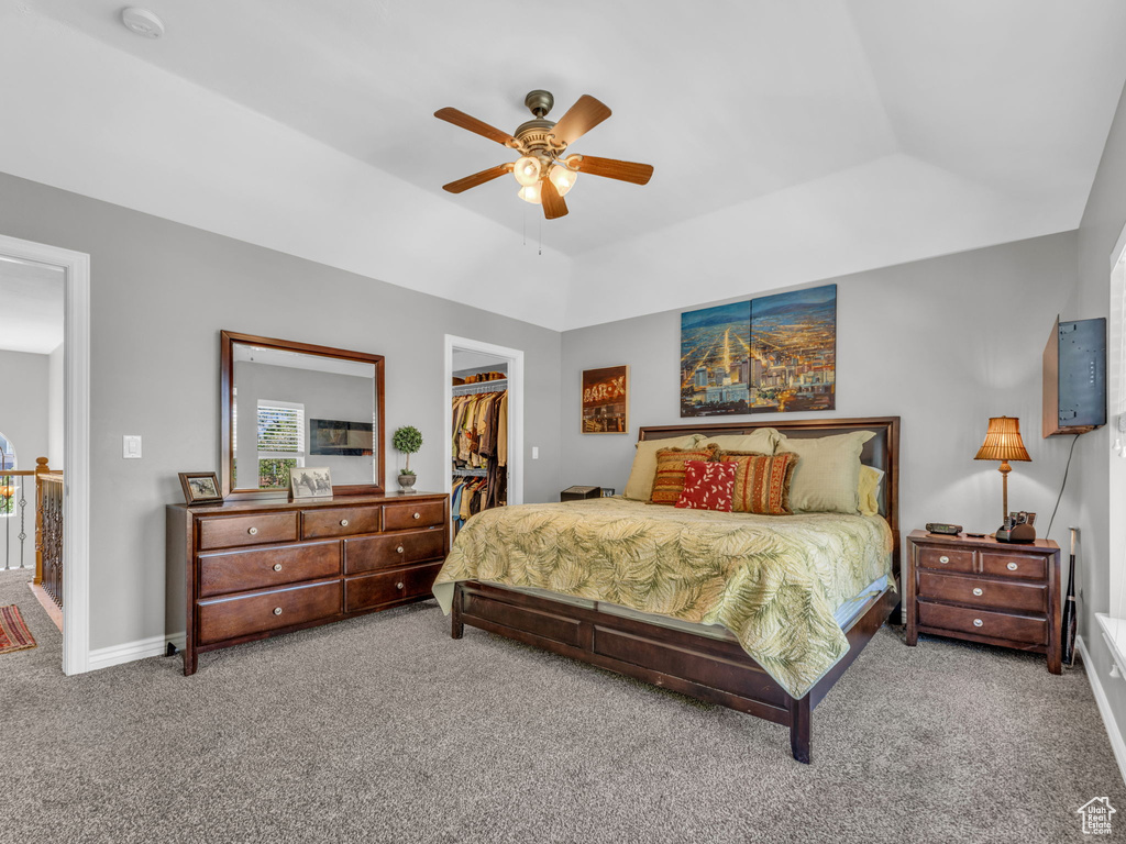 Bedroom with ceiling fan, carpet floors, baseboards, a closet, and a spacious closet