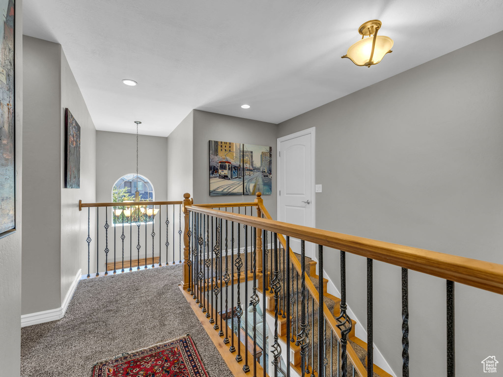 Corridor featuring recessed lighting, baseboards, an upstairs landing, and carpet