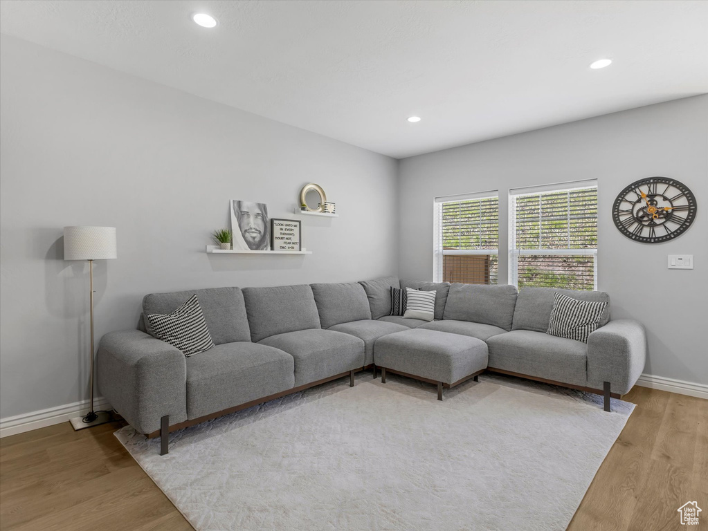 Living room with recessed lighting, baseboards, and wood finished floors