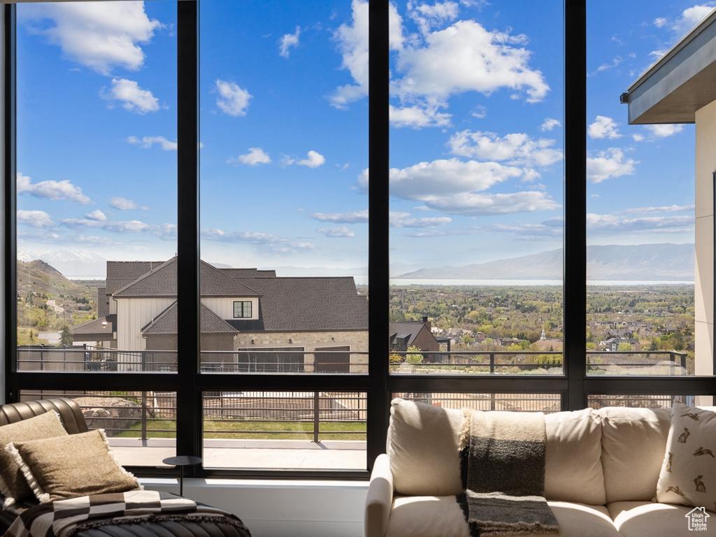 Sunroom featuring a healthy amount of sunlight and a mountain view