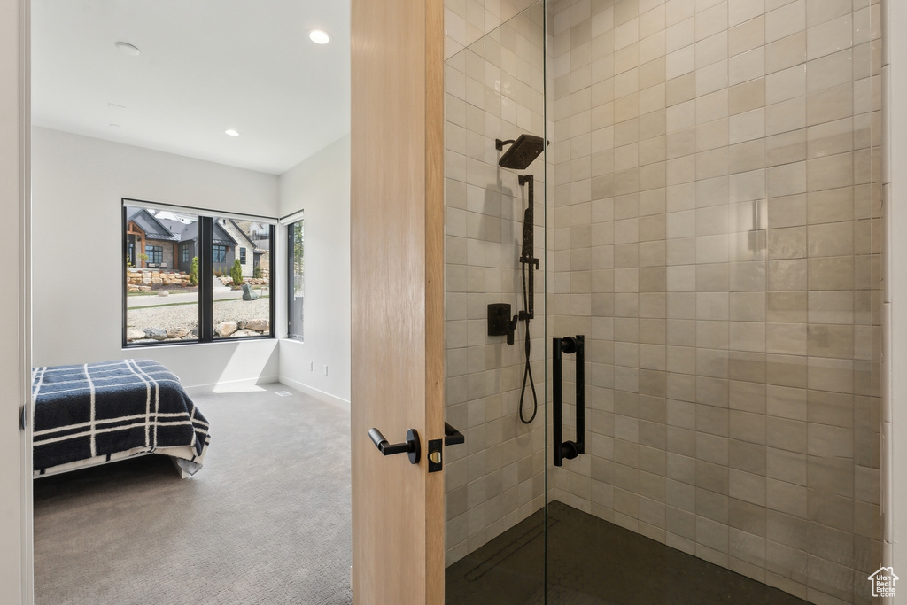 Full bathroom featuring baseboards, a stall shower, and recessed lighting