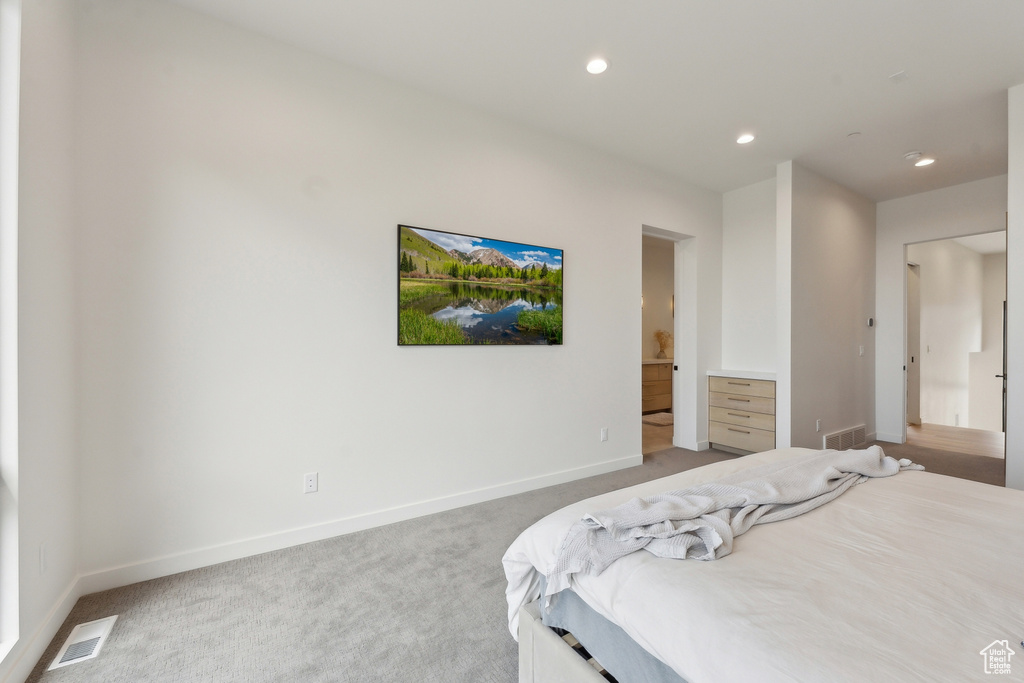 Bedroom with baseboards, light colored carpet, recessed lighting, and visible vents