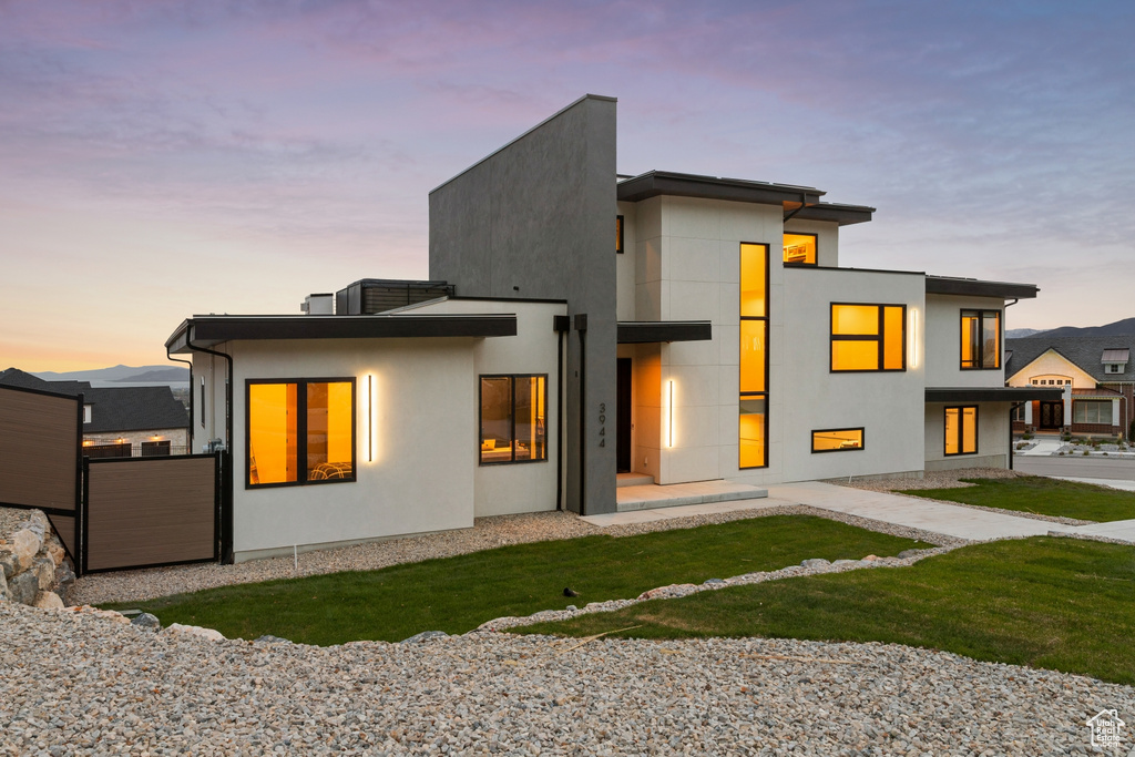View of back of property at dusk