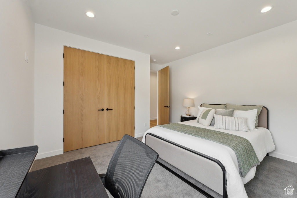 Carpeted bedroom with recessed lighting, baseboards, and a closet