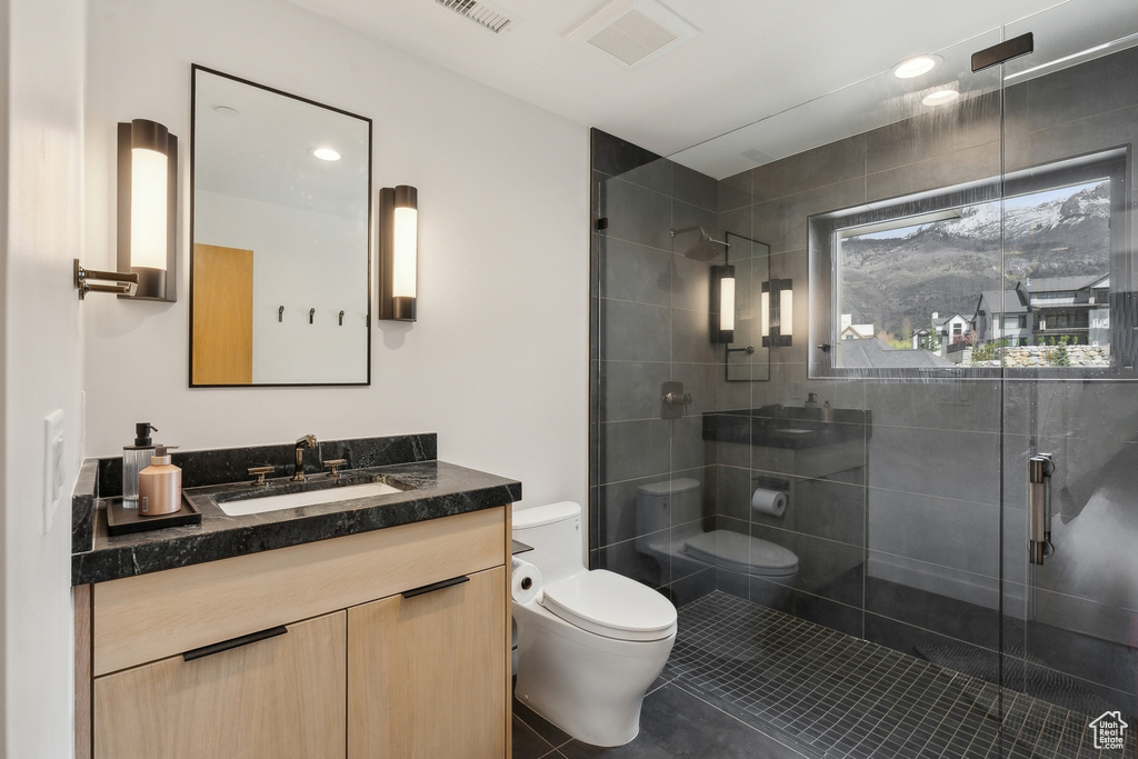 Bathroom with tile patterned floors, a stall shower, toilet, and visible vents
