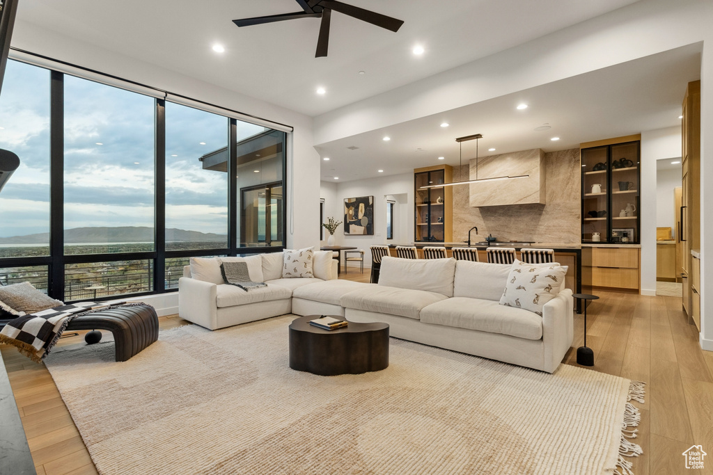 Living area featuring recessed lighting, a ceiling fan, a mountain view, and light wood-style flooring