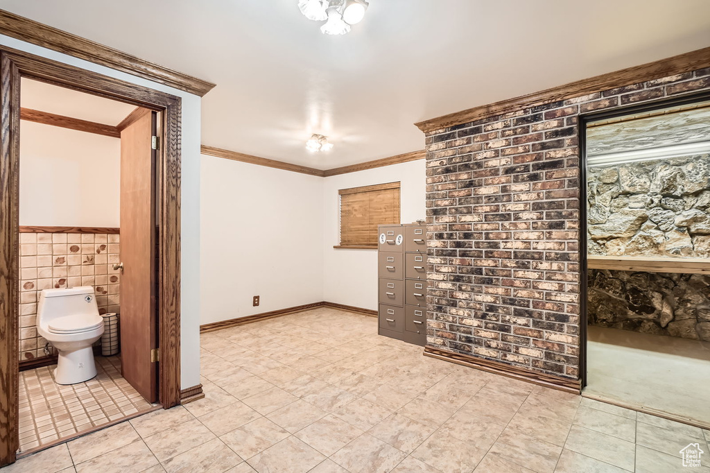 Interior space with ornamental molding and light tile patterned floors