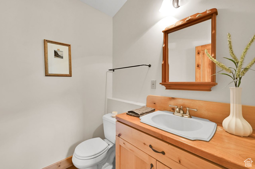 Half bath featuring toilet and vanity