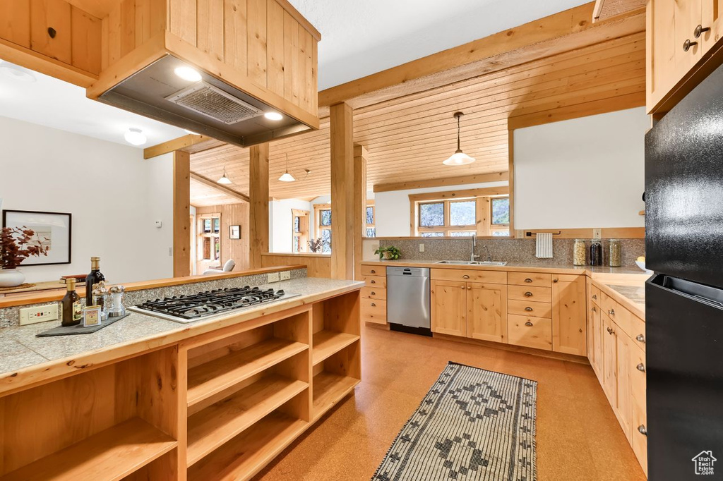 Kitchen with a sink, light brown cabinets, open shelves, and appliances with stainless steel finishes