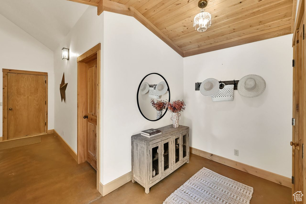 Hallway featuring baseboards, wooden ceiling, and lofted ceiling