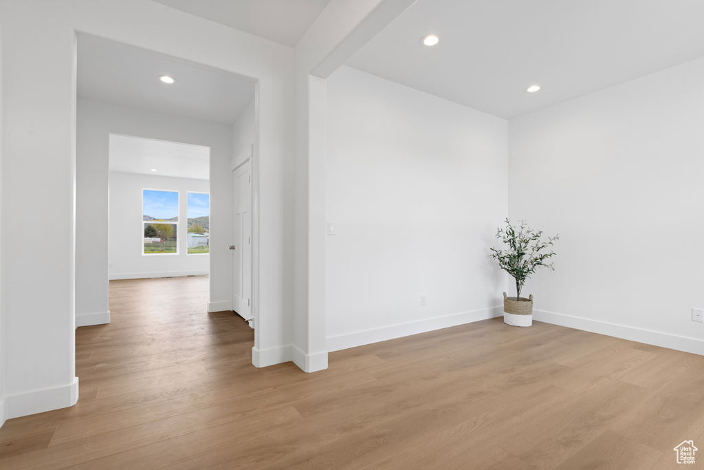 Spare room with recessed lighting, baseboards, and light wood finished floors