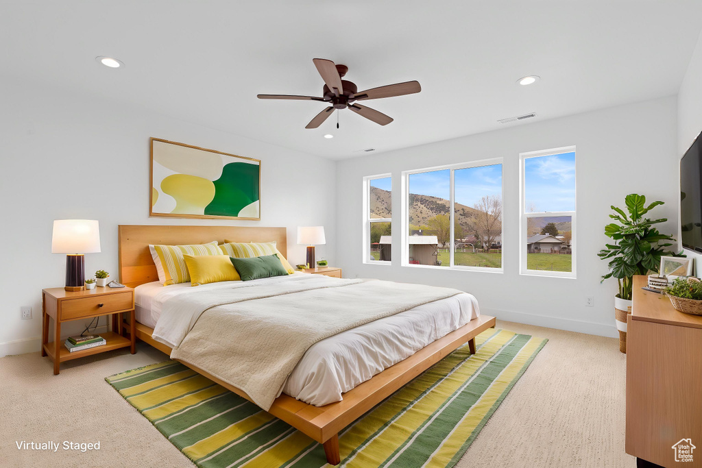 Carpeted bedroom featuring baseboards, recessed lighting, and ceiling fan