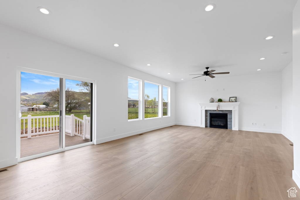 Unfurnished living room featuring recessed lighting, ceiling fan, and light wood-type flooring