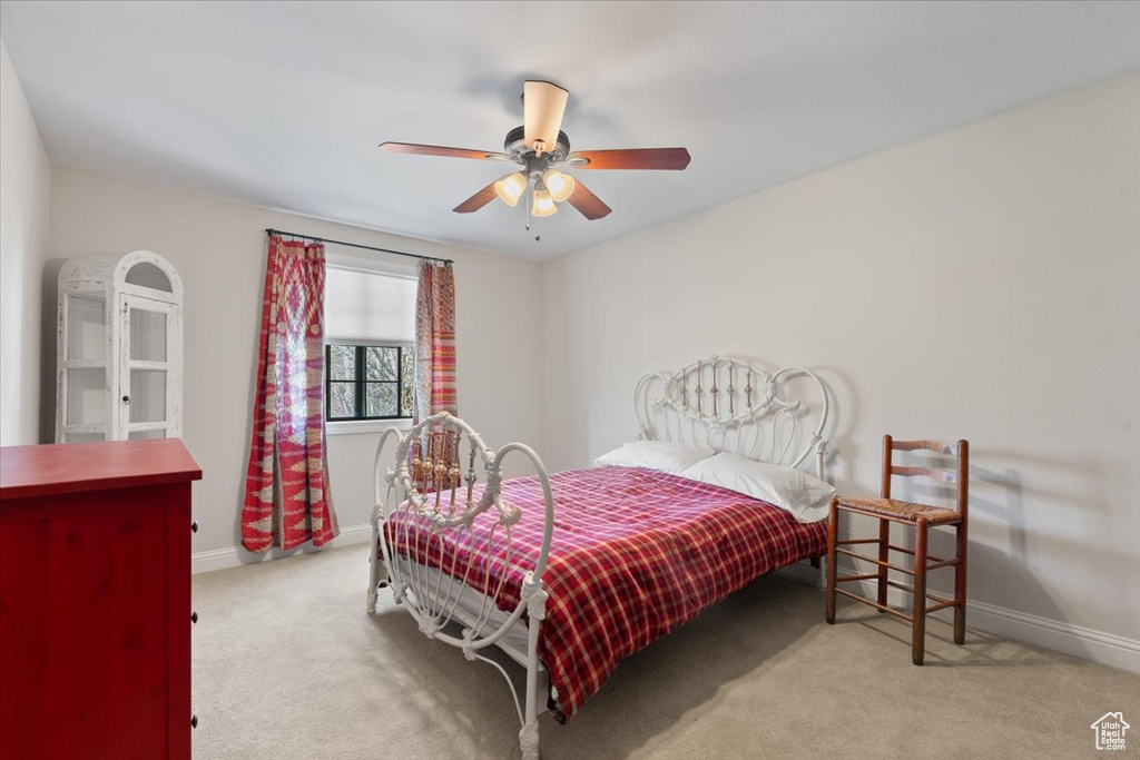 Carpeted bedroom with baseboards and ceiling fan