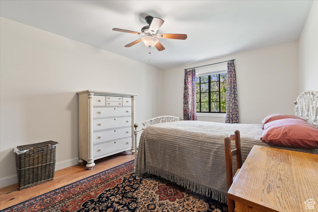 Bedroom with baseboards, a ceiling fan, and wood finished floors