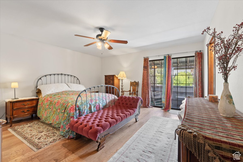 Bedroom featuring a ceiling fan, wood finished floors, and access to exterior