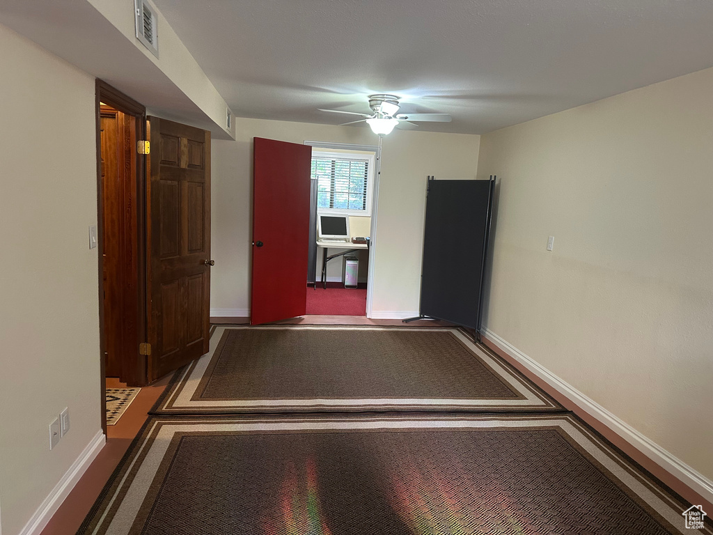 Interior space featuring a ceiling fan, baseboards, and visible vents