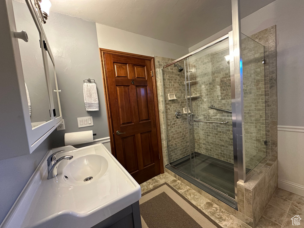 Bathroom featuring vanity and a shower stall