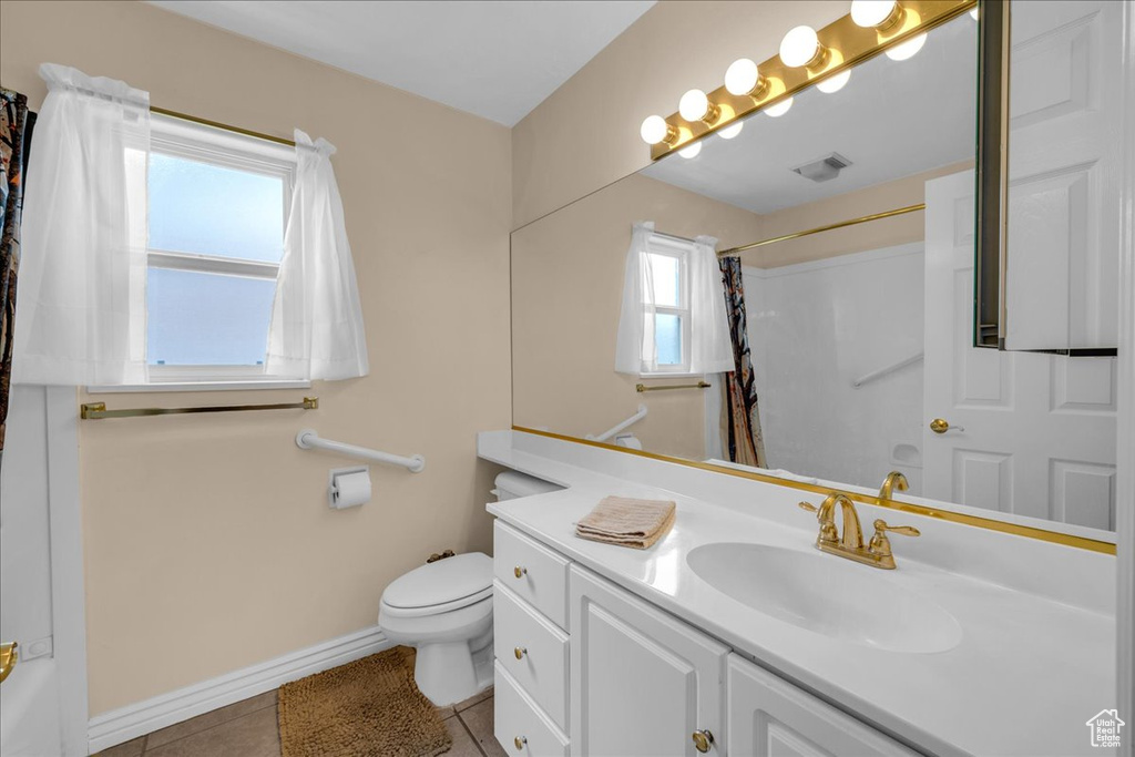 Bathroom with visible vents, tile patterned flooring, curtained shower, baseboards, and toilet