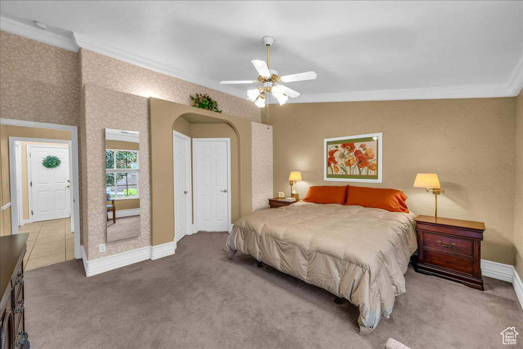 Bedroom featuring crown molding, carpet, ceiling fan, and baseboards
