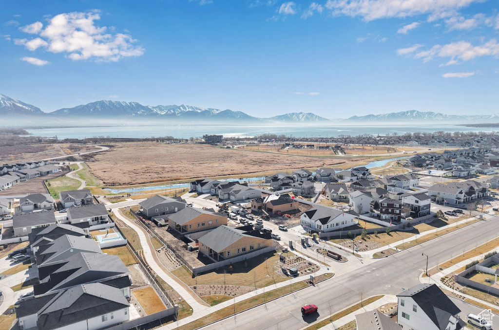 Drone / aerial view with a water and mountain view and a residential view