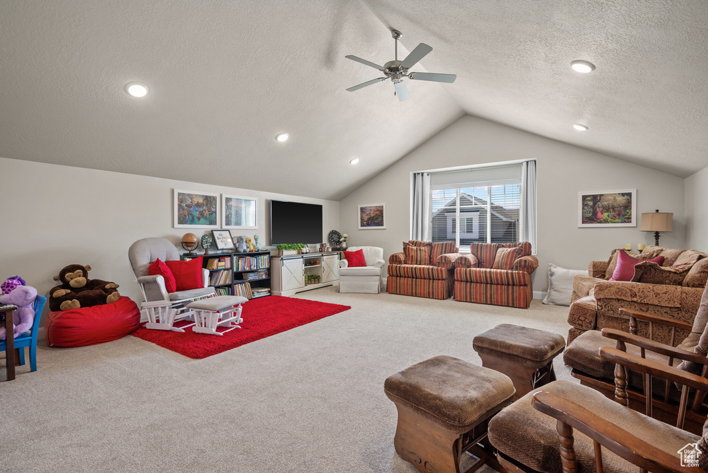 Carpeted living room with a ceiling fan, vaulted ceiling, recessed lighting, and a textured ceiling