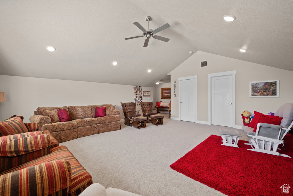 Carpeted living area featuring visible vents, a ceiling fan, vaulted ceiling, and recessed lighting