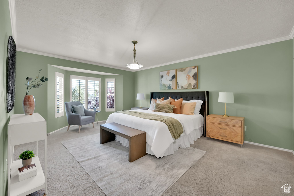 Bedroom featuring crown molding, baseboards, and carpet floors