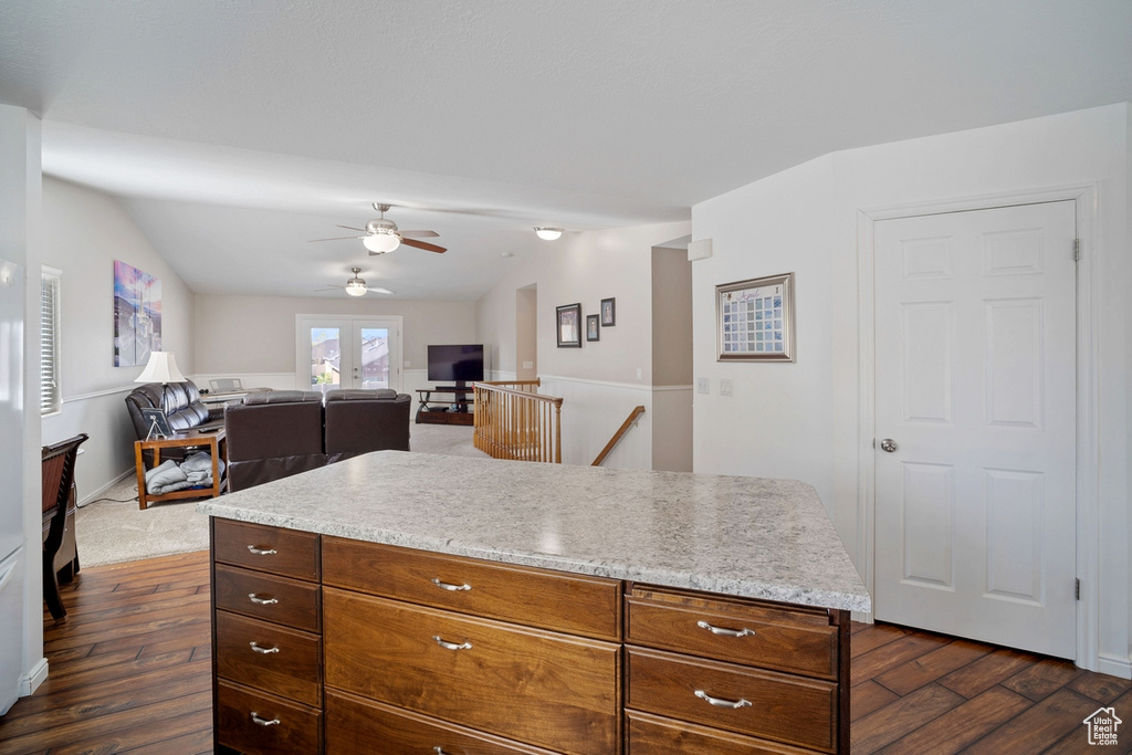Kitchen featuring dark wood-style flooring, ceiling fan, and lofted ceiling