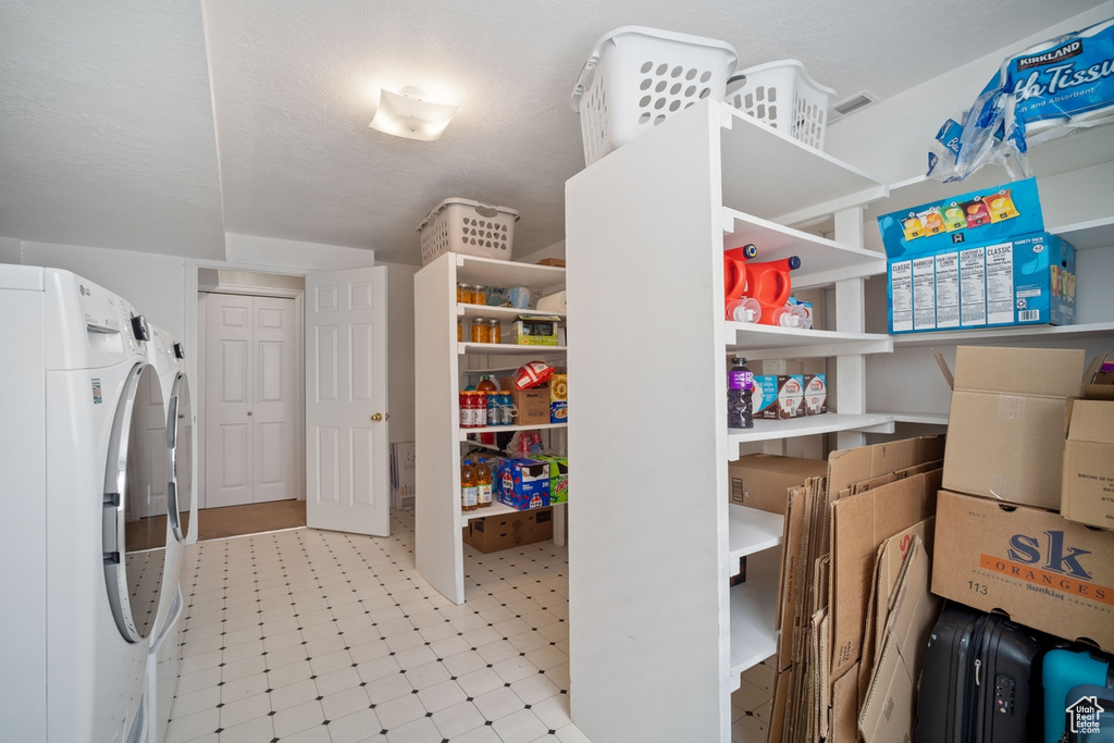 Laundry room featuring washer and dryer, laundry area, and light floors