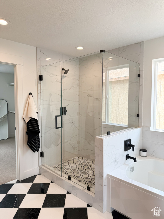 Bathroom with a marble finish shower, a garden tub, recessed lighting, and a textured ceiling
