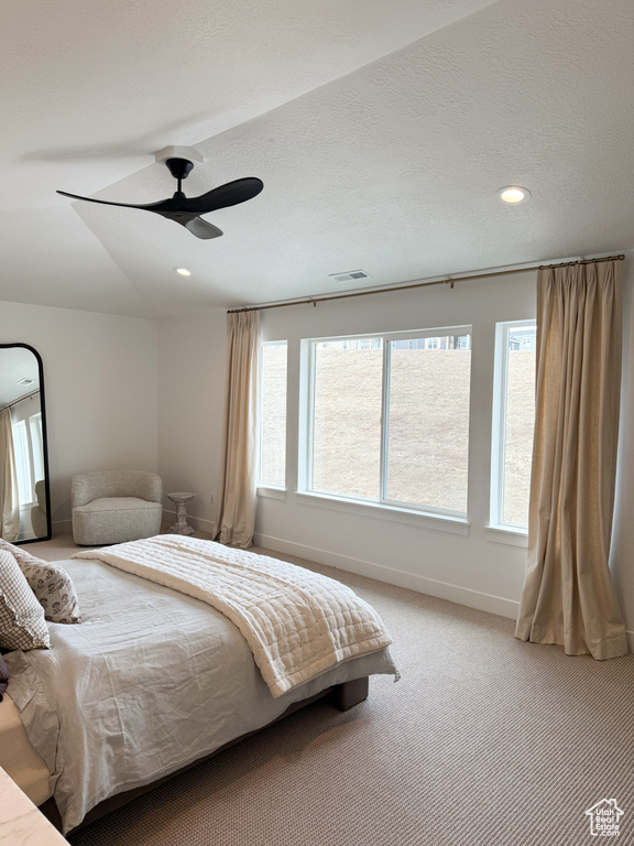 Bedroom featuring baseboards, light carpet, recessed lighting, and visible vents