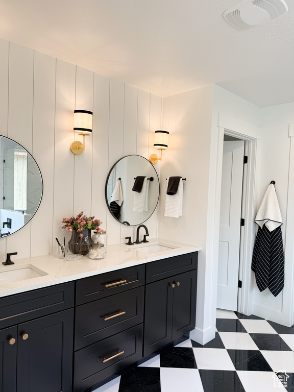 Full bath with a sink, tile patterned floors, and double vanity