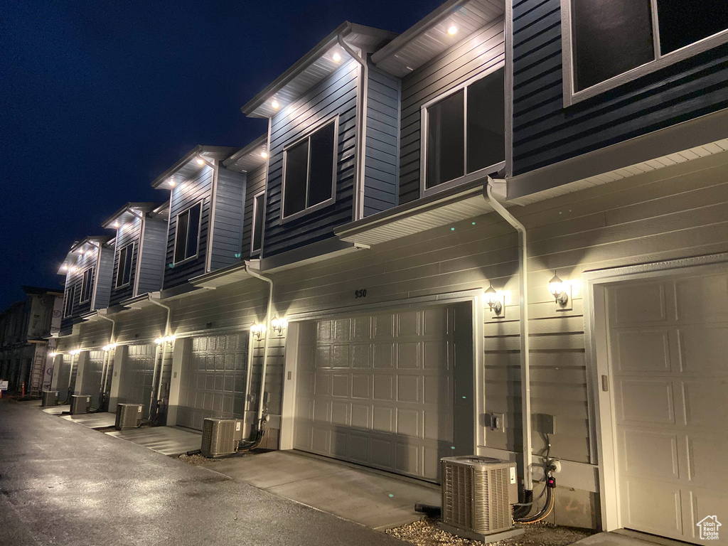 Exterior space with a garage and central AC unit