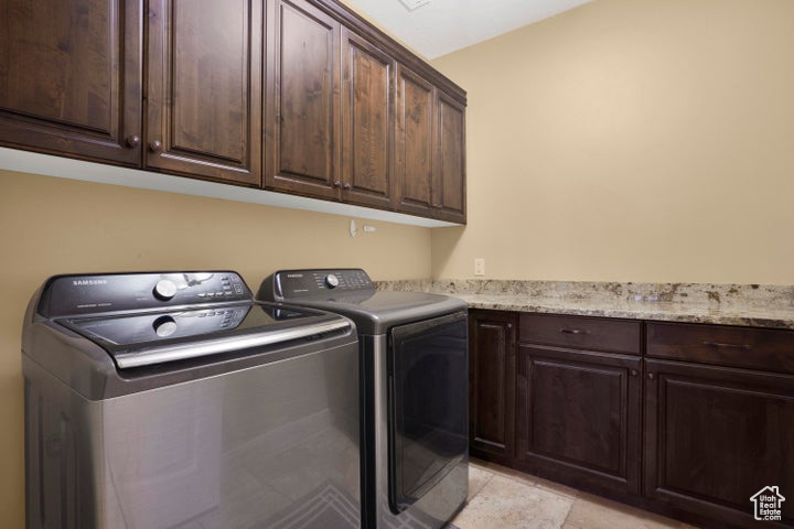 Laundry area with cabinet space and washer and clothes dryer