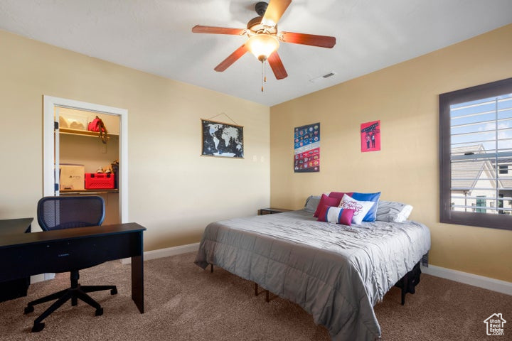 Bedroom featuring carpet floors, baseboards, and ceiling fan