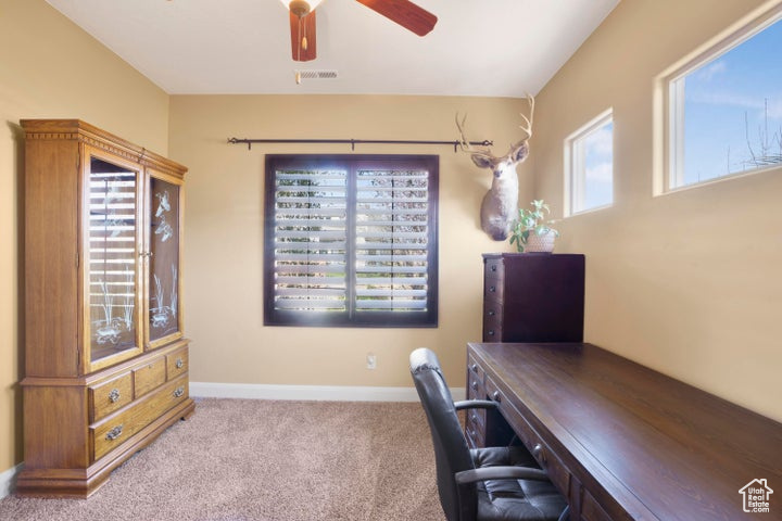Home office featuring carpet floors, a ceiling fan, baseboards, and visible vents