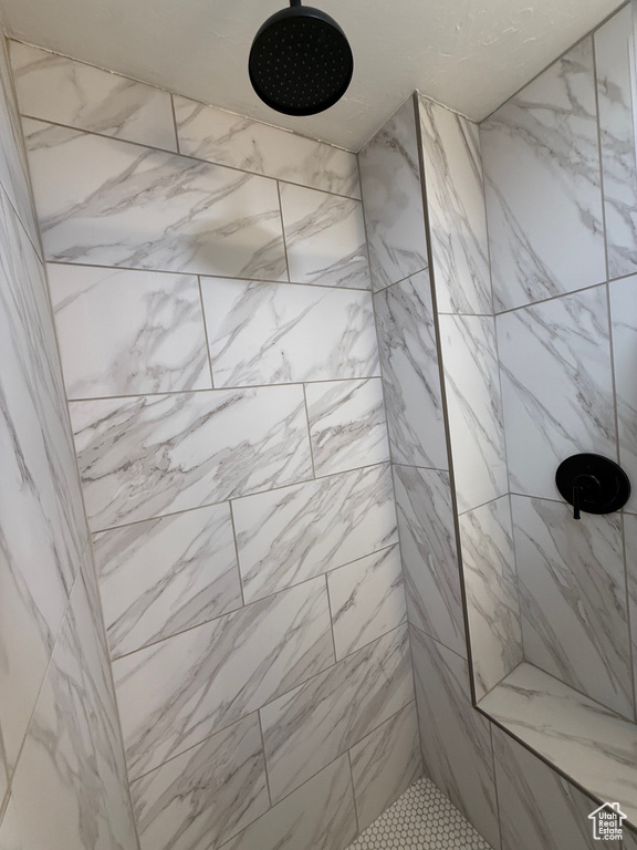 Full bath featuring a tile shower