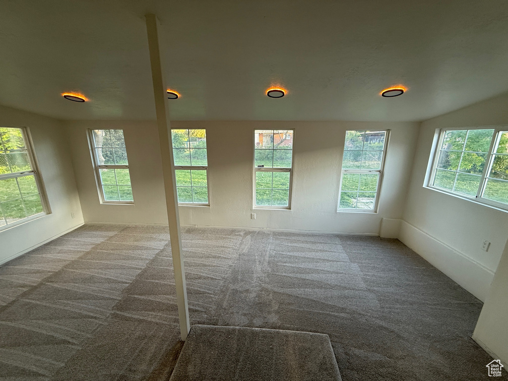 Carpeted spare room with a healthy amount of sunlight