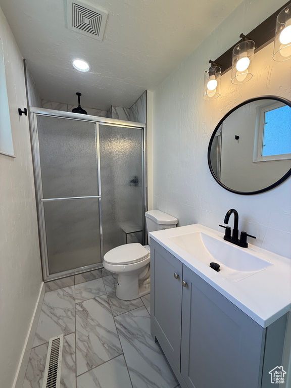 Bathroom featuring visible vents, a shower stall, marble finish floor, and vanity
