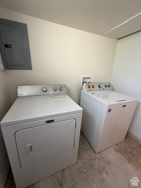 Laundry area featuring electric panel, independent washer and dryer, and laundry area
