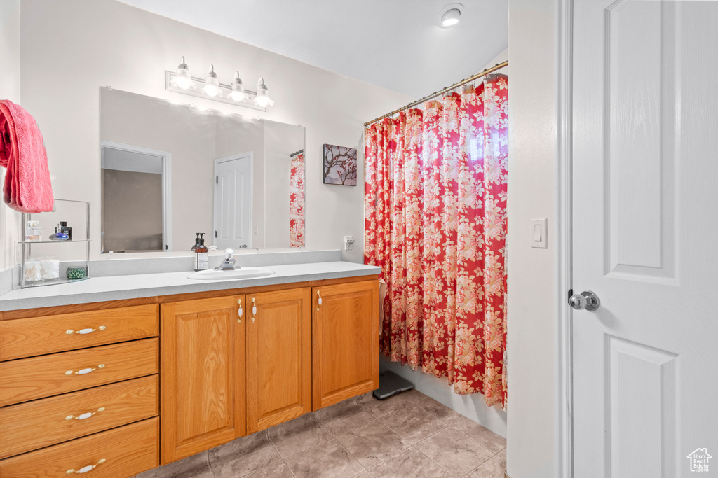 Full bathroom featuring vanity and a shower with curtain