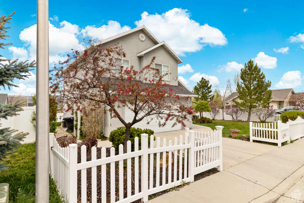 View of front facade featuring a fenced front yard and stucco siding