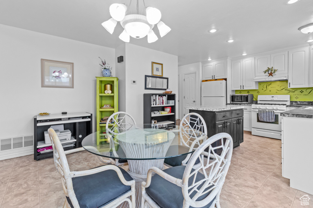Dining space with recessed lighting, a notable chandelier, visible vents, and light tile patterned floors