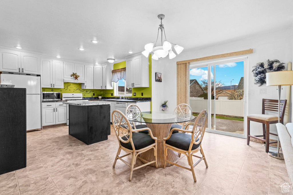 Dining room featuring an inviting chandelier, recessed lighting, and a wealth of natural light