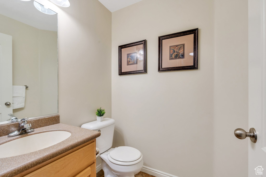 Half bathroom with vanity and toilet