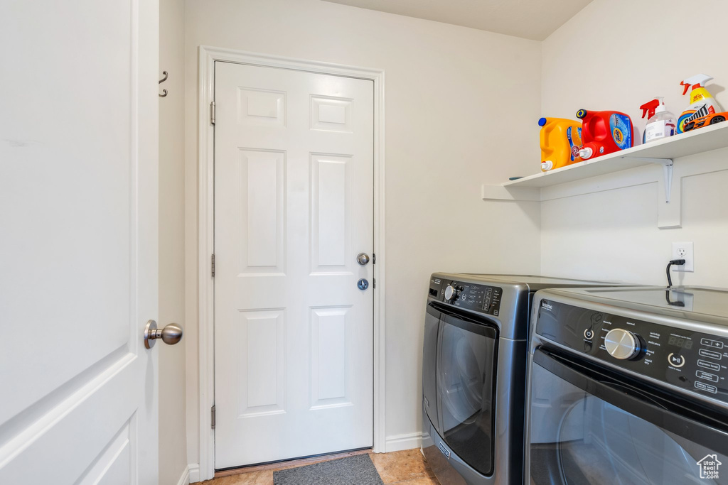 Laundry area featuring laundry area, baseboards, and washing machine and dryer