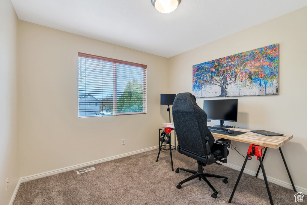 Carpeted home office with baseboards and visible vents